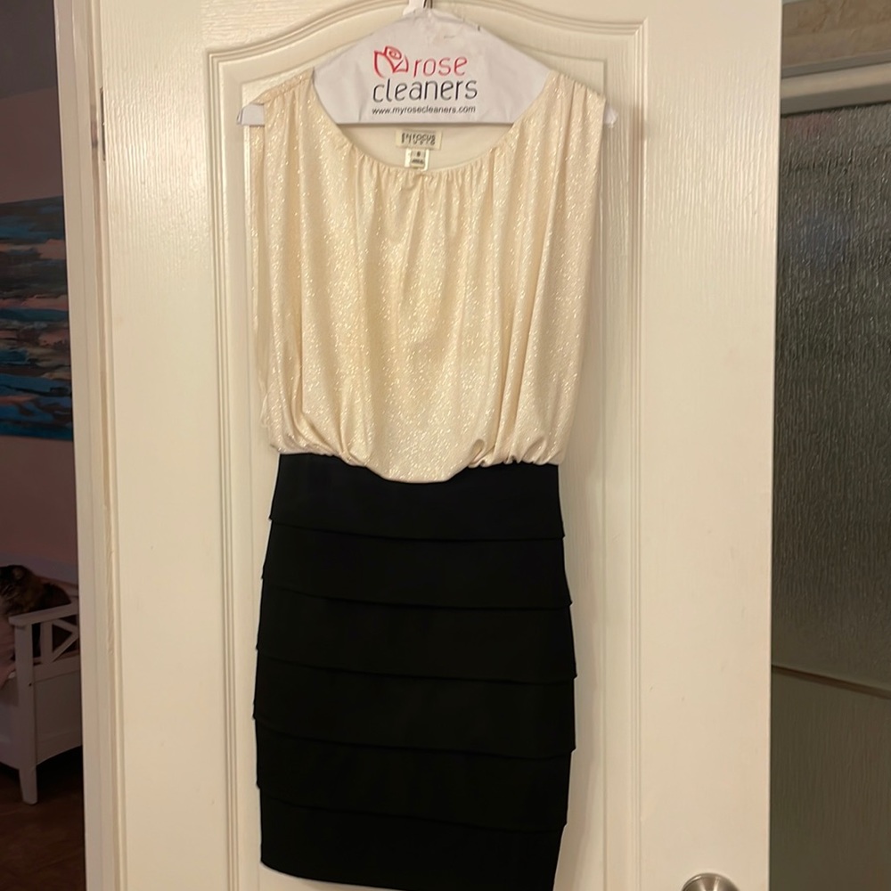 Off white and black dress. Too sparkles. Stretchy bottom.